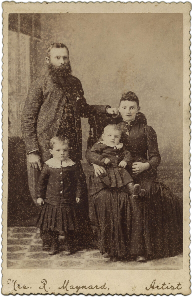 A photographic portrait of a man, woman, and two children.