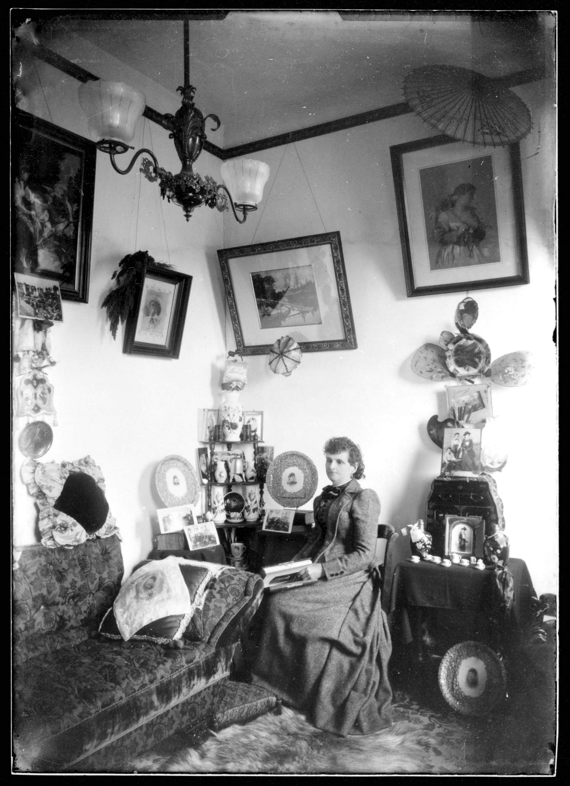 A black and white photo of Maynard sitting in her parlour.